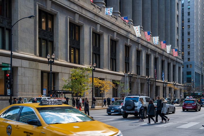 Outside of the City Hall Building and people crossing the street